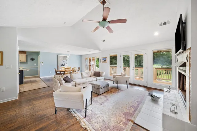 a living room with furniture large window and a flat screen tv