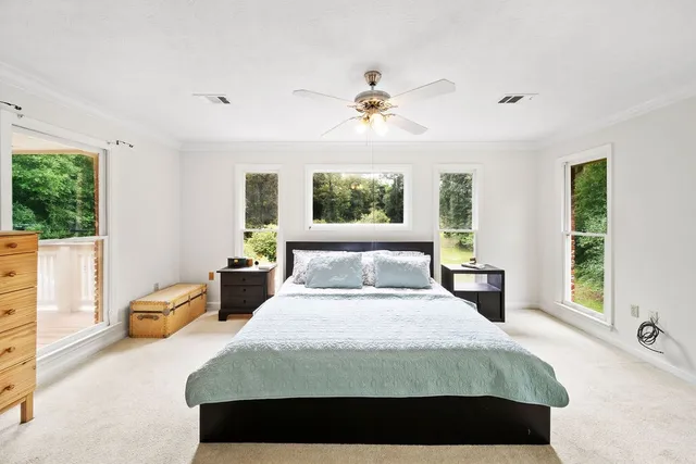 a bedroom with a large bed and a window