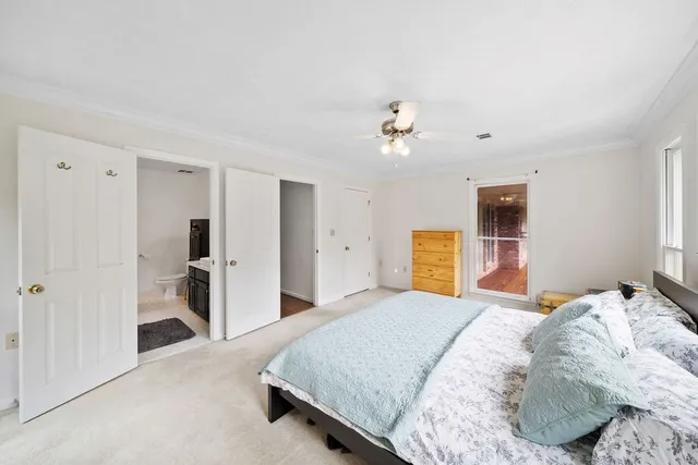 a bedroom with a bed and a view of bathroom