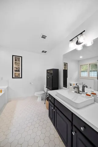 a large bathroom with a sink double vanity and a mirror