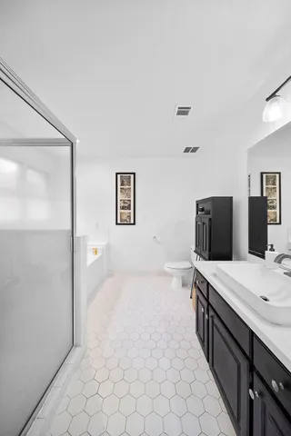 a spacious bathroom with a double vanity sink mirror and