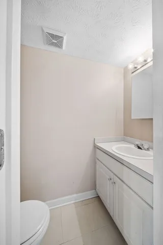 a bathroom with a sink a toilet and vanity