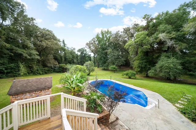 a view of a yard with wooden fence