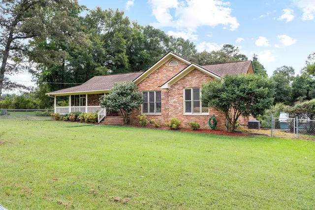 a front view of a house with a garden