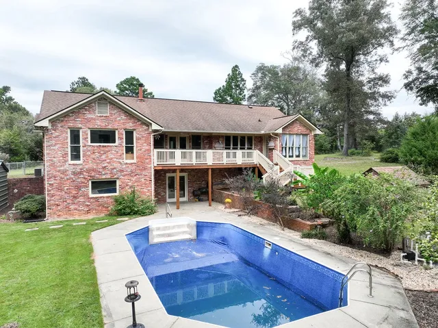 a front view of a house with a yard garage and outdoor seating