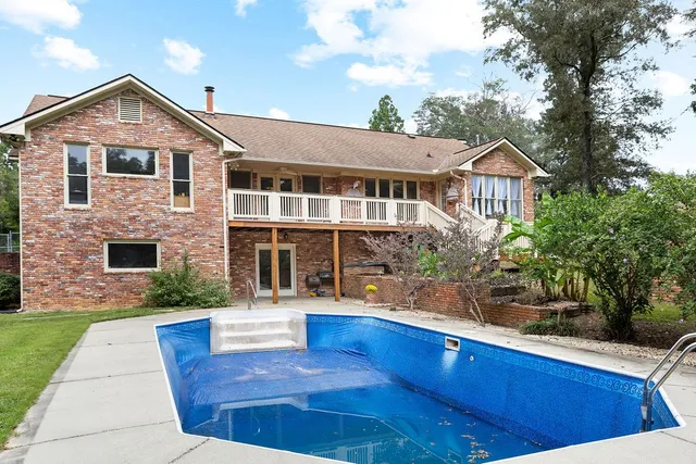 a front view of house with yard and trees around