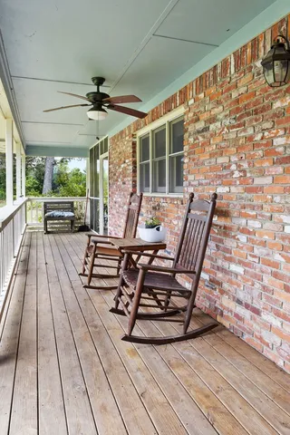 a view of a patio with table and chairs and wooden floor