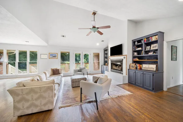 a living room with furniture fireplace and flat screen tv