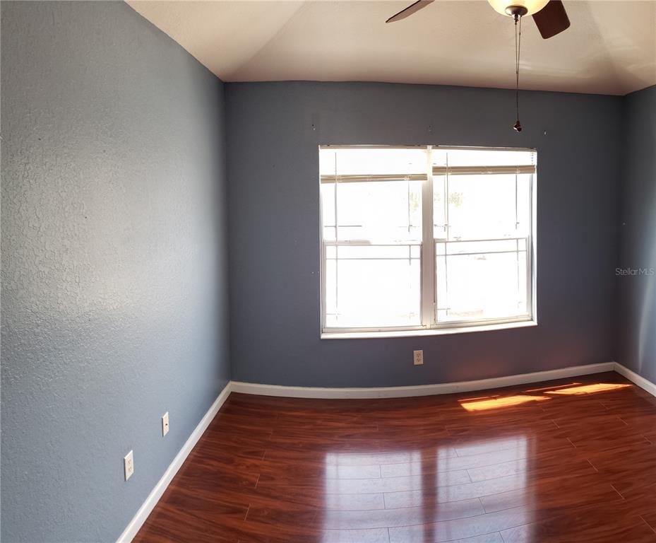 4245 Southwest 50th Circle Ocala, FL 34474 - Photo 10 of 14 a view of empty room with wooden floor and fan