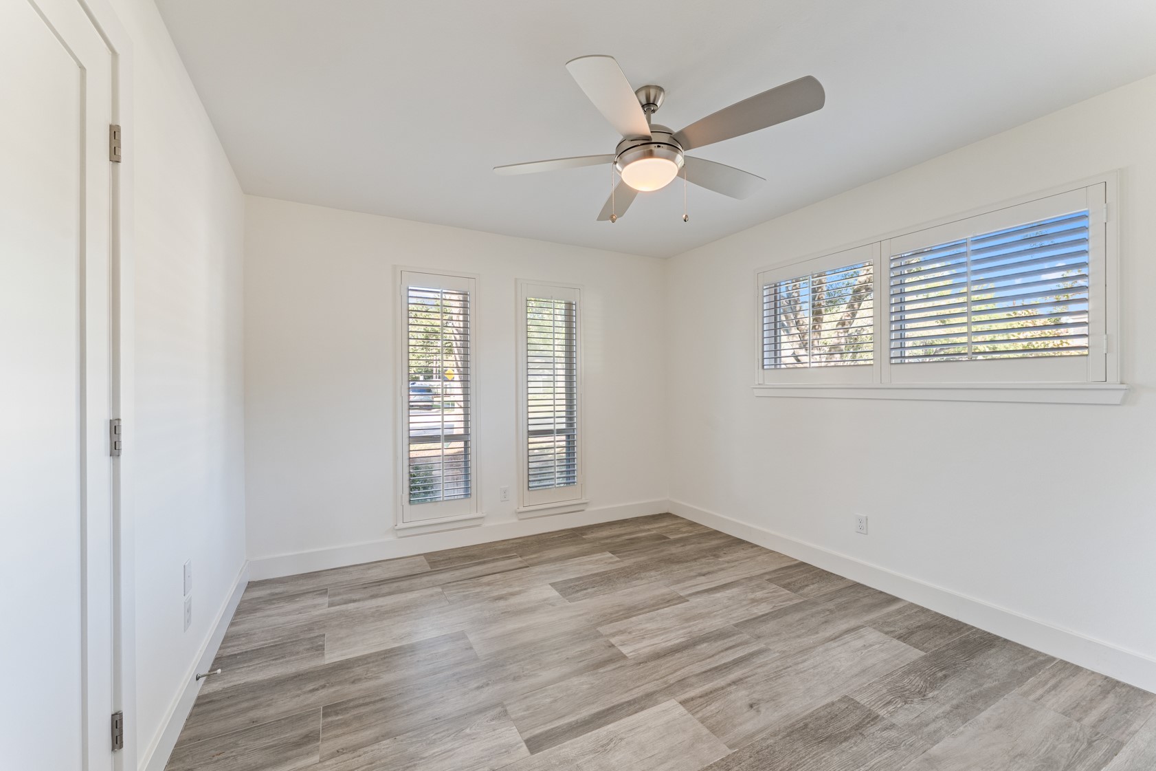 10703 Deerwood Road Houston, TX 77042 - Photo 14 of 28 Another guest bedroom with incredible natural light, Plantation shutters, and Porcelain tile flooring which continues throughout the home.