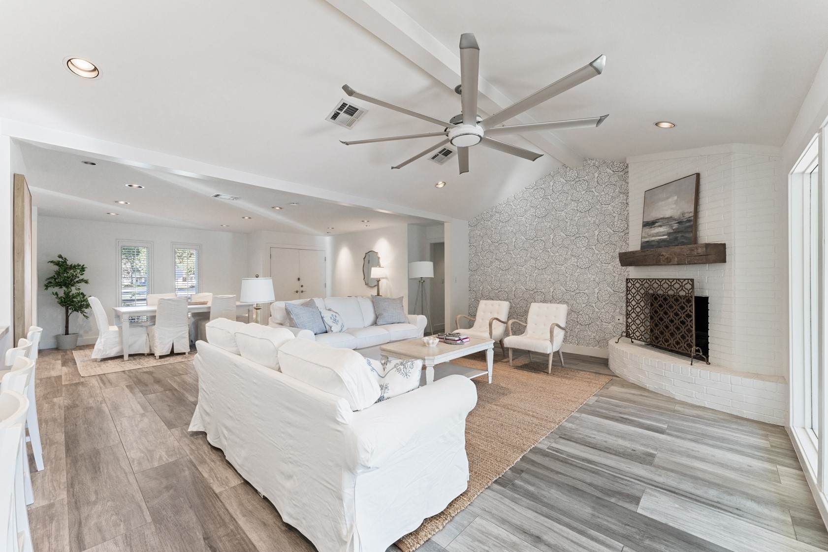 10703 Deerwood Road Houston, TX 77042 - Photo 2 of 28 Living area is complimented by vaulted ceilings, recessed lighting, and porcelain tile flooring which continues throughout.