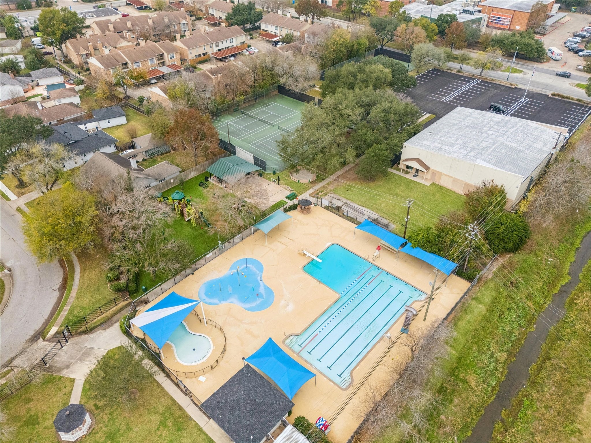 10703 Deerwood Road Houston, TX 77042 - Photo 22 of 28 The Walnut Bend Rec Center offers a variety of amenities for residents, including a family pool, pavilion, park, a gymnasium with a basketball court, tennis and pickleball courts, and a playground.