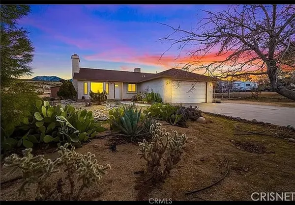 a yellow house with trees in front of it