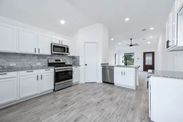 a kitchen with a white cabinets and white appliances