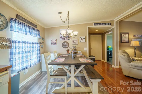 a view of a dining room with furniture and chandelier