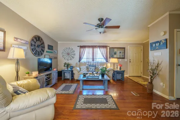 a living room with furniture wooden floor and a fireplace