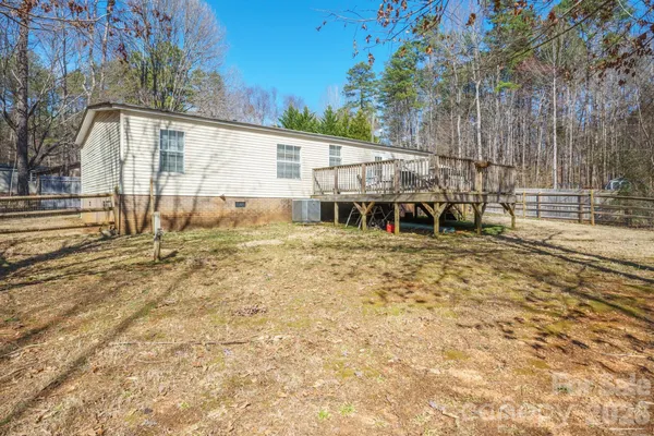 a view of a house with backyard and a tree