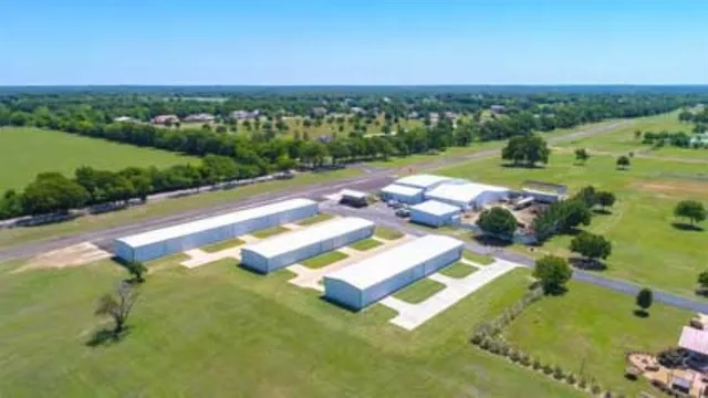 an aerial view of a house with swimming pool and outdoor seating