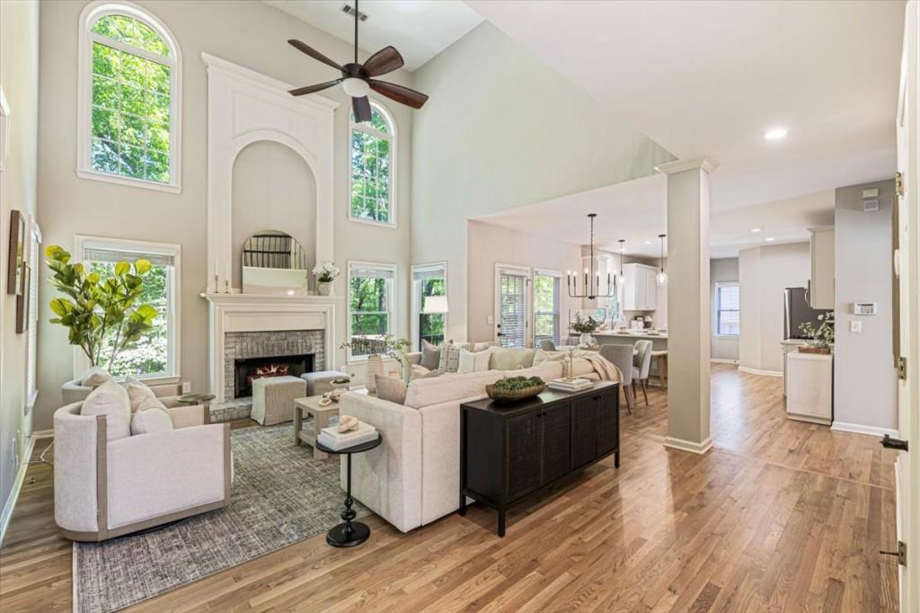 1110 Compass Pointe Crossing Alpharetta, GA 30005 - Photo 14 of 55 a living room with furniture a fireplace and a chandelier