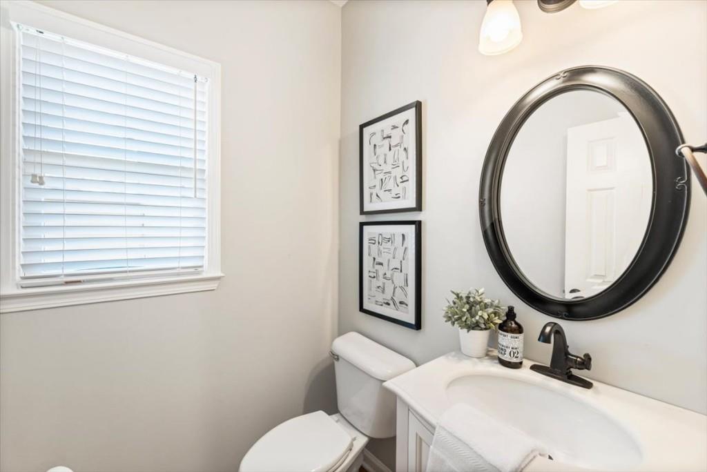1110 Compass Pointe Crossing Alpharetta, GA 30005 - Photo 27 of 55 a bathroom with a toilet a sink and a mirror