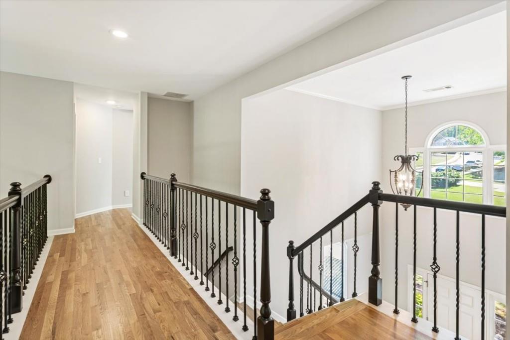 1110 Compass Pointe Crossing Alpharetta, GA 30005 - Photo 29 of 55 a view of a hallway with wooden floor and staircase
