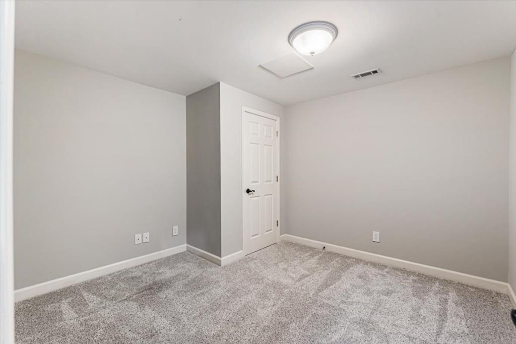 1110 Compass Pointe Crossing Alpharetta, GA 30005 - Photo 49 of 55 an empty room with a chandelier fan