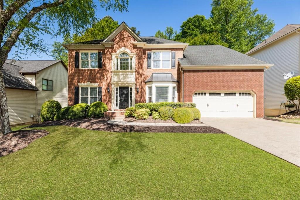 1110 Compass Pointe Crossing Alpharetta, GA 30005 - Photo 6 of 55 a front view of a house with a garden and plants