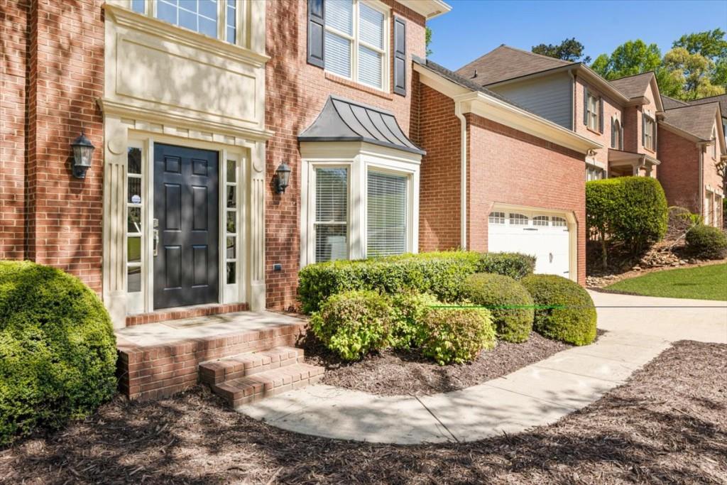 1110 Compass Pointe Crossing Alpharetta, GA 30005 - Photo 7 of 55 a view of a brick building next to a yard