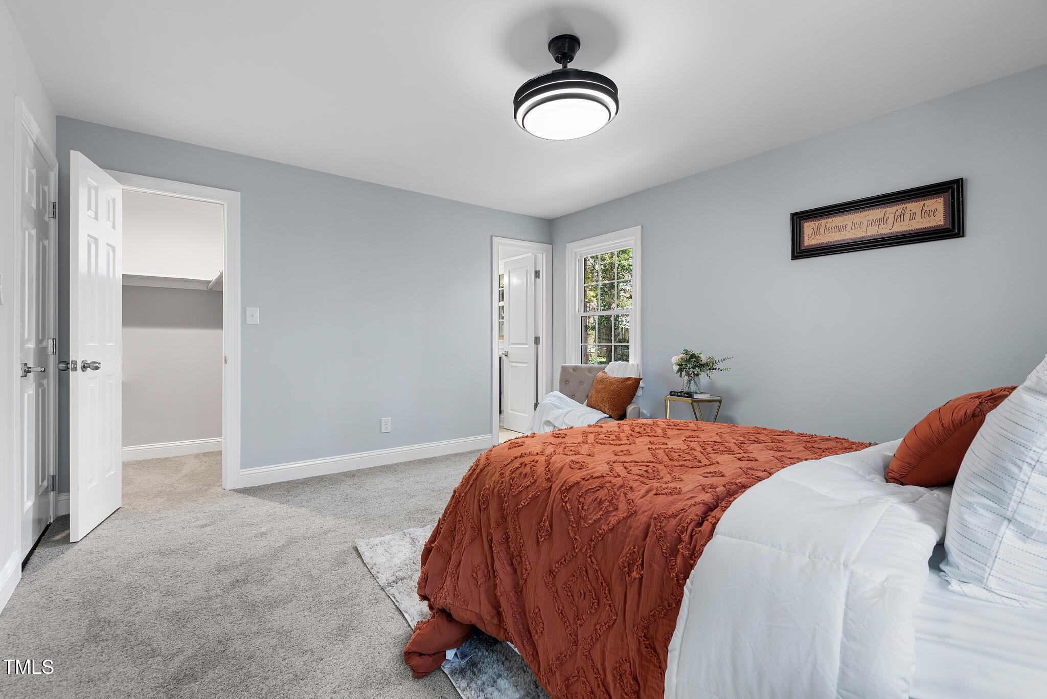 5812 Timber Ridge Drive Raleigh, NC 27609 - Photo 21 of 38 a bedroom with a bed and a chandelier