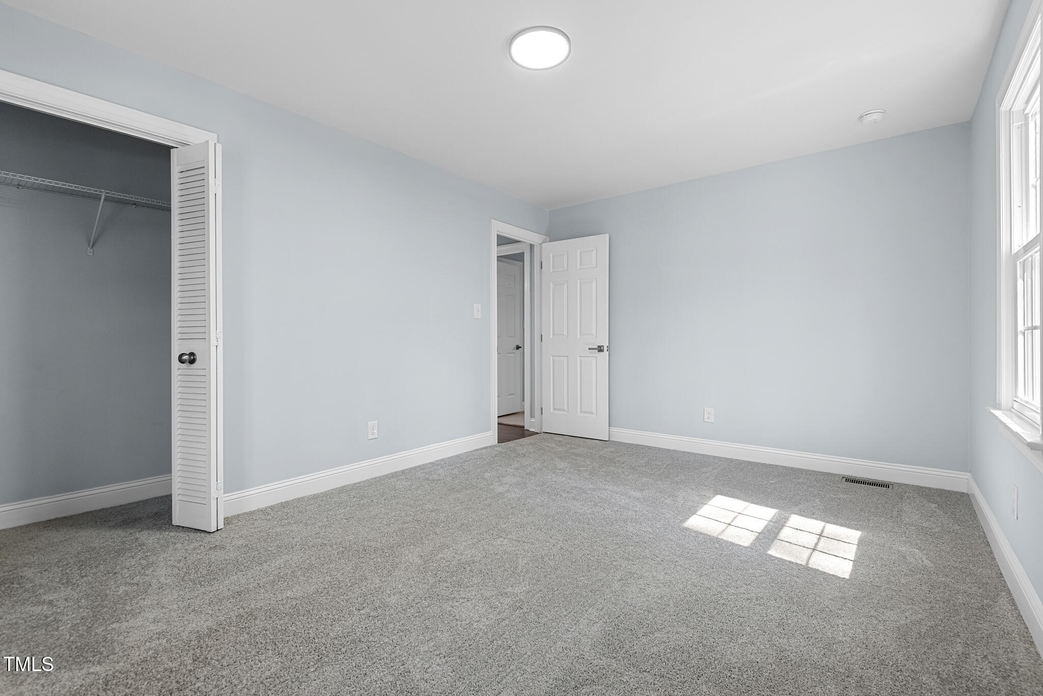 5812 Timber Ridge Drive Raleigh, NC 27609 - Photo 32 of 38 an empty room with a empty space and a window