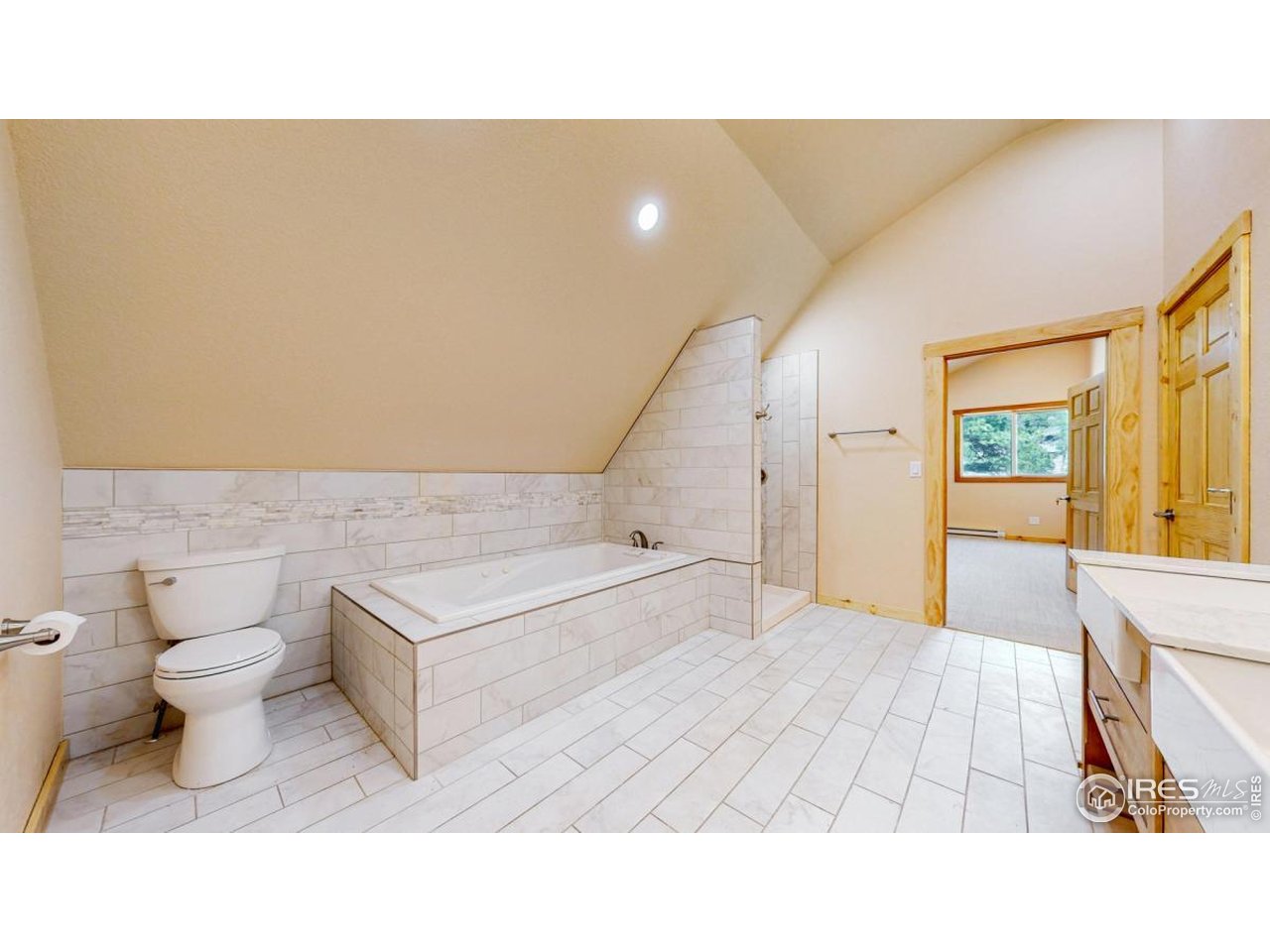 598 Taylor Road Lyons, CO 80540 - Photo 14 of 32 a bathroom with a sink a toilet and bathtub