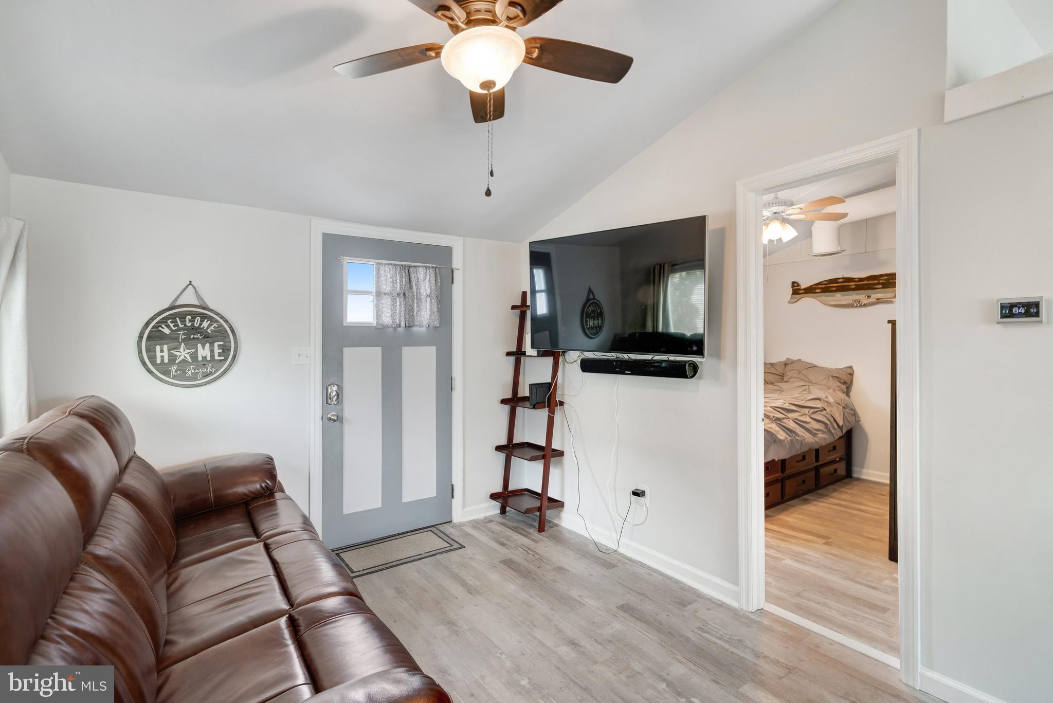 80 Dolphin Road Tuckerton, NJ 08087 - Photo 17 of 33 a living room with furniture a flat screen tv and a ceiling fan