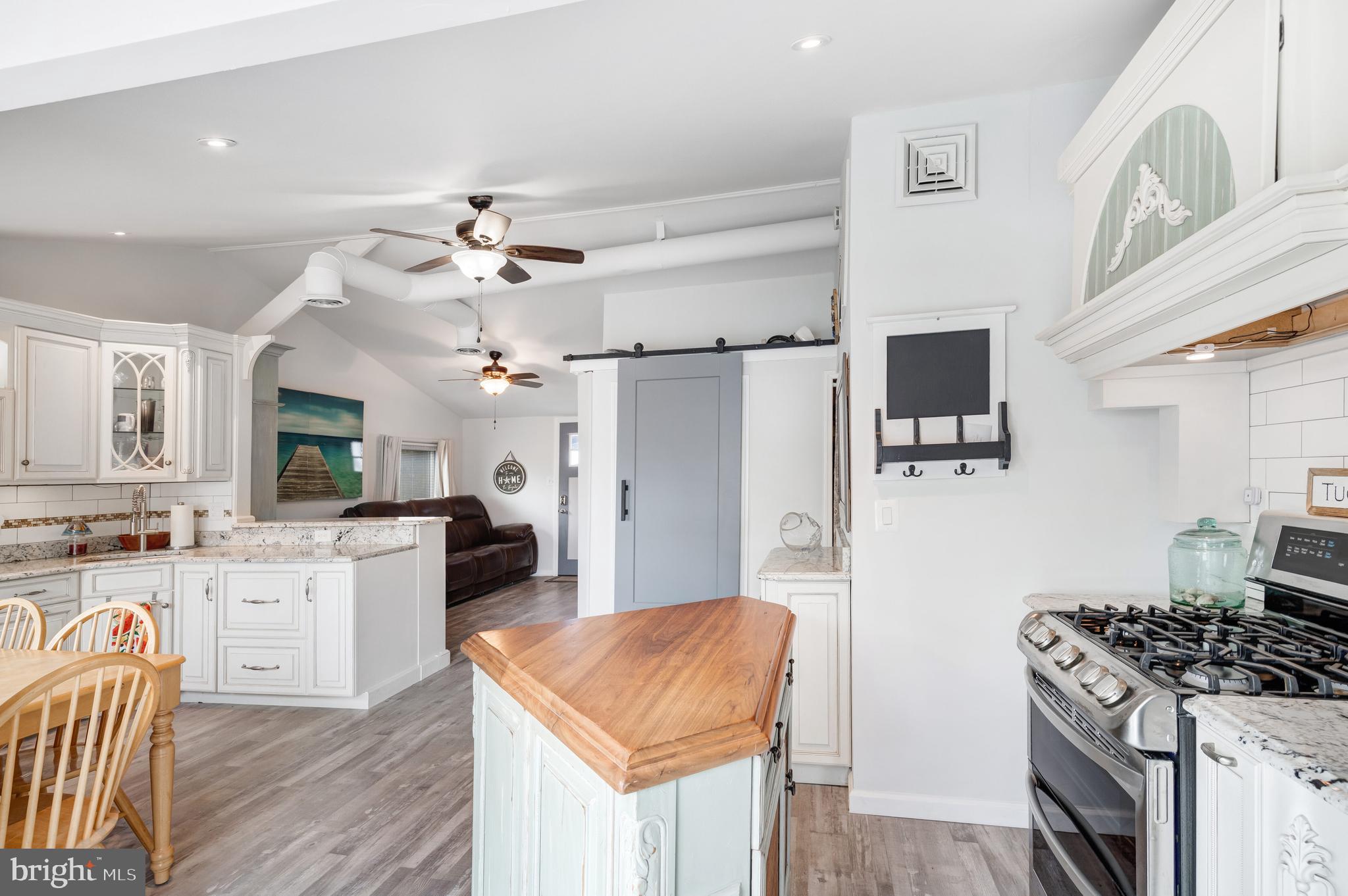 80 Dolphin Road Tuckerton, NJ 08087 - Photo 25 of 33 a kitchen with stainless steel appliances granite countertop a stove a sink dishwasher and a refrigerator with wooden floor