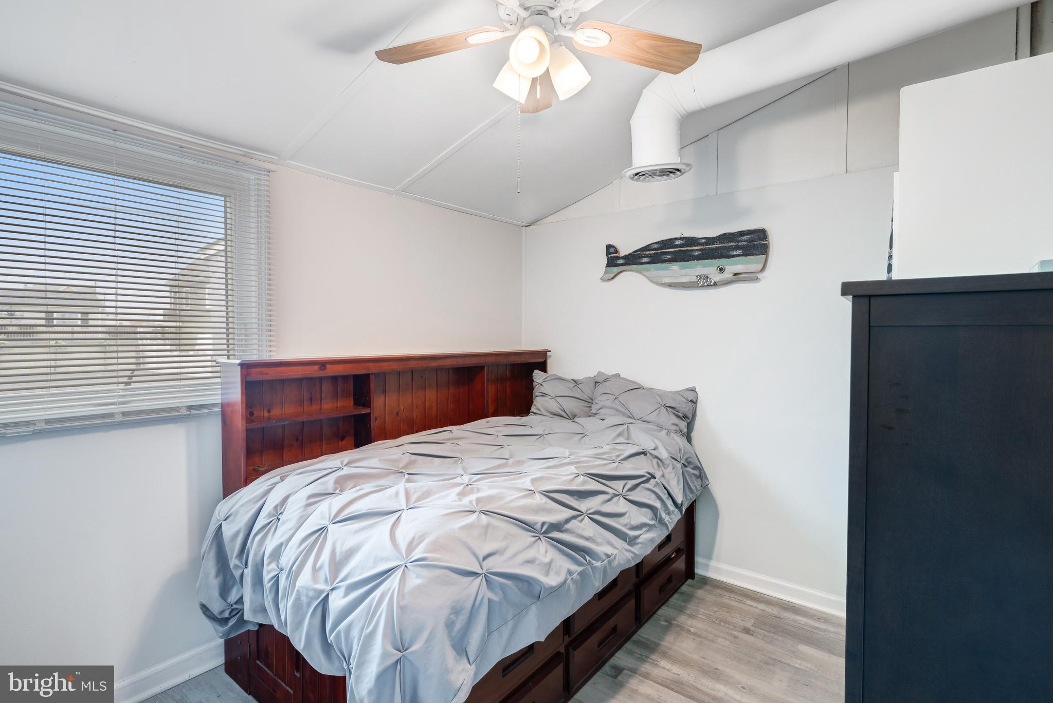 80 Dolphin Road Tuckerton, NJ 08087 - Photo 31 of 33 a bedroom with a bed and a chandelier