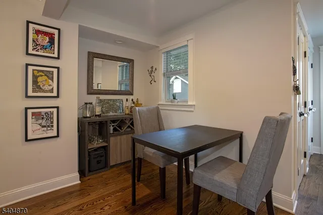 a view of a workspace with furniture and wooden floor