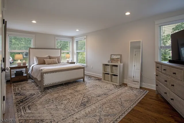 a bed room with a bed and a television