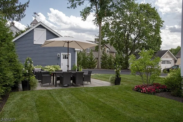 a view of a chair and table in the garden