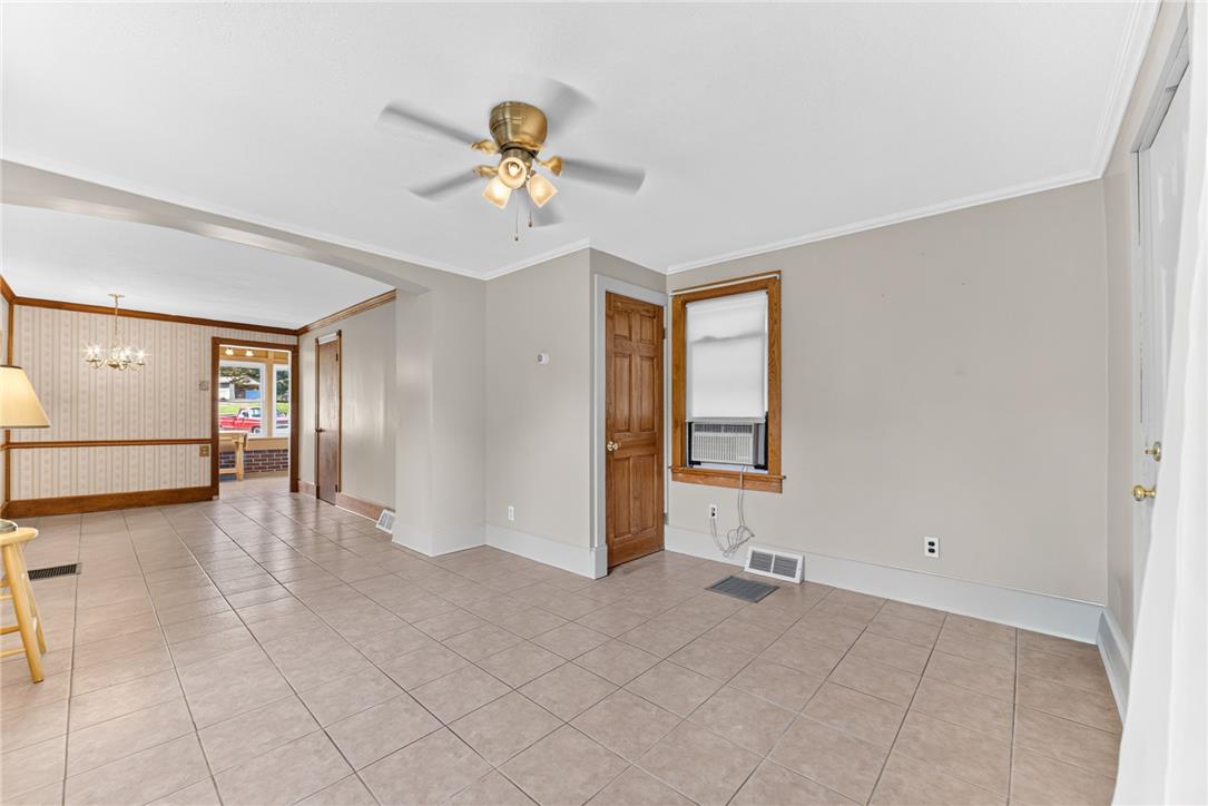 1166 Stones Crossing Road Easton, PA 18045 - Photo 9 of 35 A living space offers tiled flooring, a ceiling fan, and a view into an adjacent dining area.
