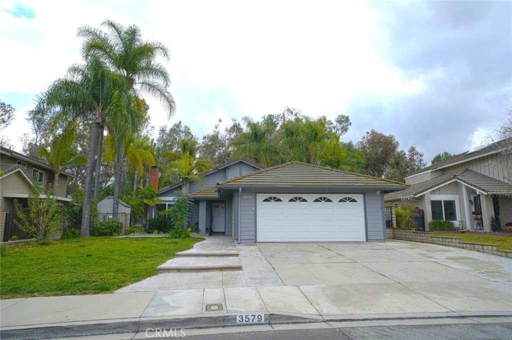 3579 Hillsdale Ranch Road Chino Hills, CA 91709 - Photo 1 of 1 a front view of a house with a garden and palm trees