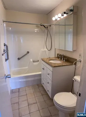 a large bed sitting in a room next to a window
