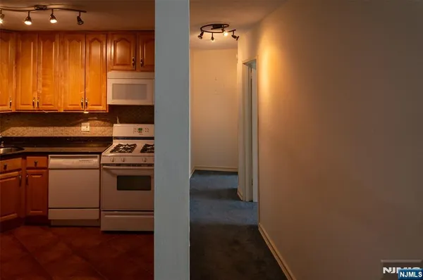 a kitchen with a refrigerator and a stove