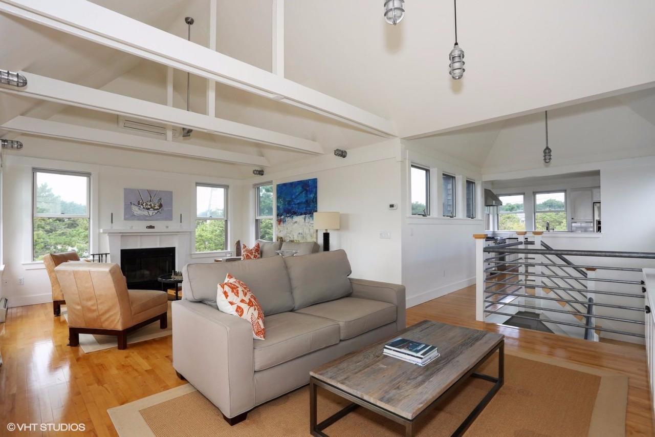 2 Avocet Road Truro, MA 02666 - Photo 5 of 24 a living room with furniture a fireplace and a chandelier