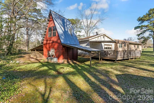 a view of a house with a yard patio and deck