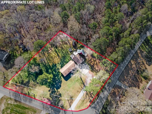 an aerial view of a house swimming pool and red chairs
