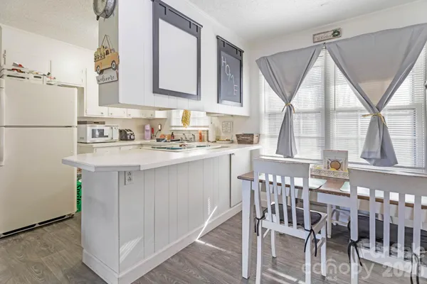 a kitchen with a sink a window and cabinets