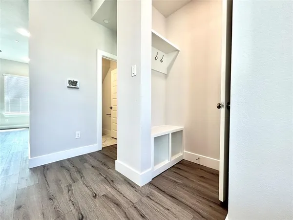 a view of entryway and hall with wooden floor