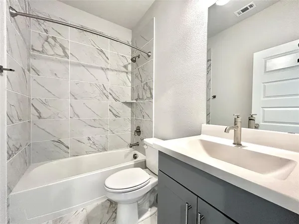 a bathroom with a shower and a sink