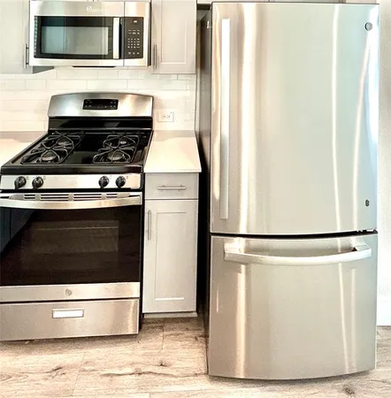 a view of stove top oven and refrigerator