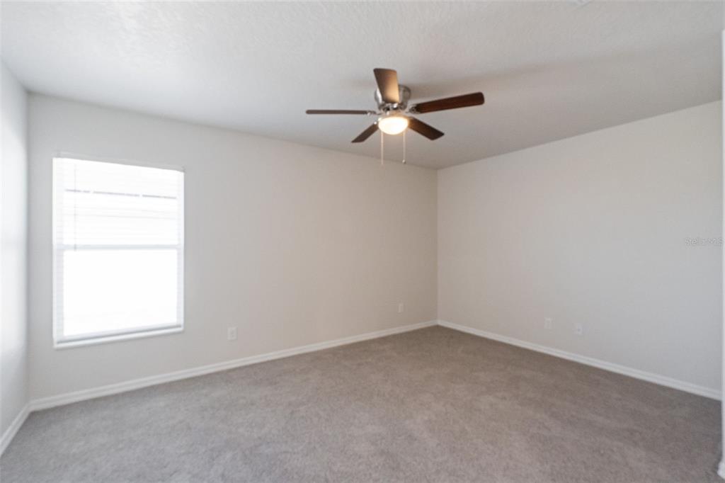 1729 Canaan Loop Dundee, FL 33838 - Photo 14 of 33 an empty room with a window and a fan