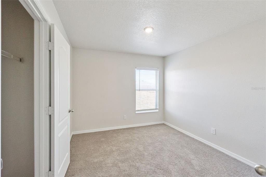 1729 Canaan Loop Dundee, FL 33838 - Photo 22 of 33 an empty room with windows